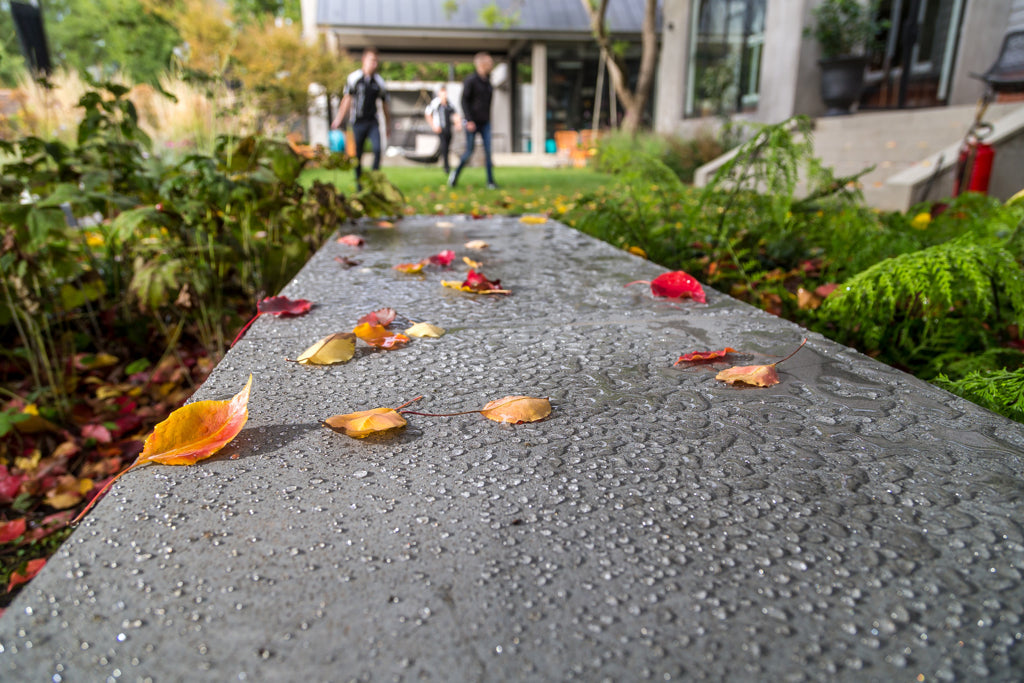 Water beading on sealed bluestone pavers at prestige Melbourne property, demonstrating penetrating stone sealer protection