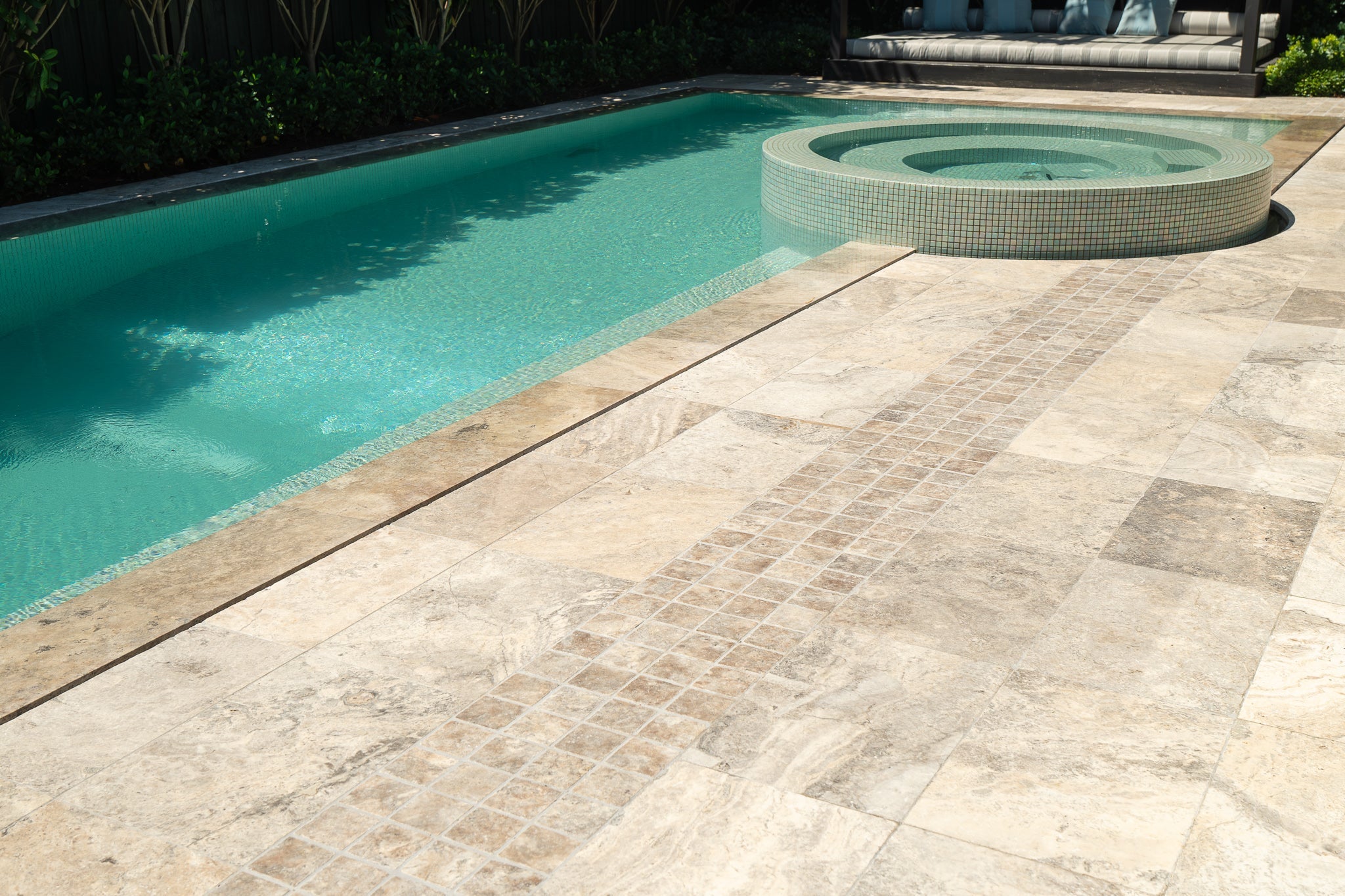 Travertine pool surround at a prestige residential property, pool and spa with full stone paving